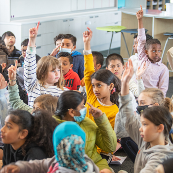 children raising their hands